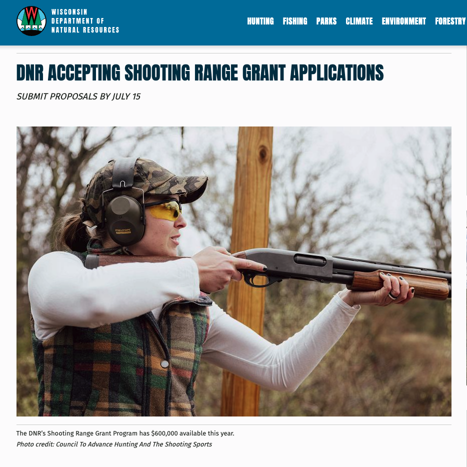Woman wearing ear and eye protection aims a shotgun at an outdoor shooting range. The image accompanies a Wisconsin Department of Natural Resources grant announcement showing Pittman-Robertson funding being used for shooting range construction and upgrades, illustrating the diversion of conservation funds toward hunter recruitment and shooting sports promotion.
